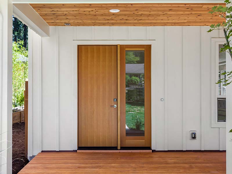 Wooden double entry door with a wood deck